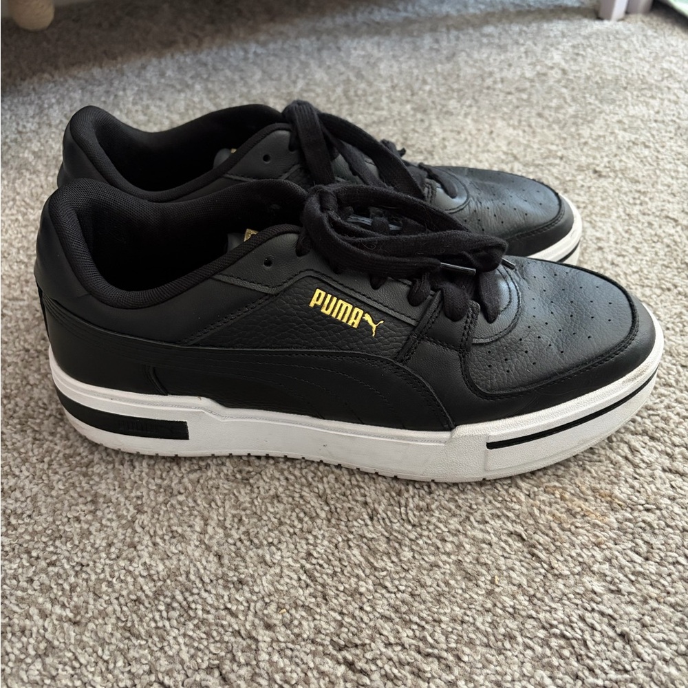 Puma Black Athletic Shoes with Gold Accents